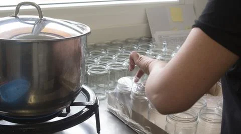 Manual capping in the artisanal process of making organic yogurt Stock Photos