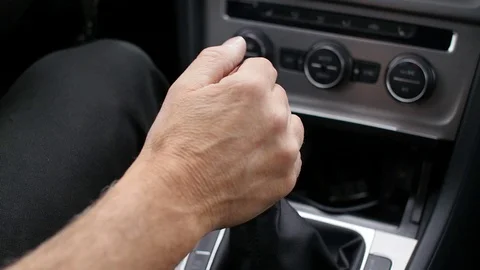 Manual car shift gear changed by hand in automobile interior Stock Footage 75064556