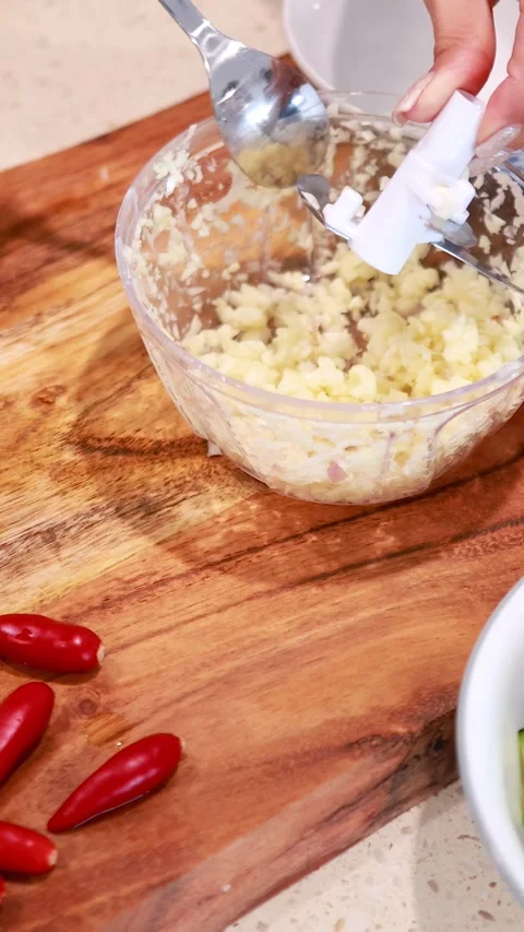 Manual Chopper Preparing Garlic in Kitchen Setting Stock Footage 307371134