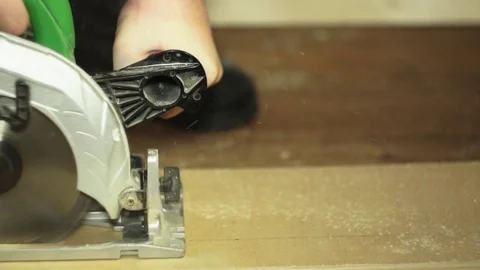 Manual circular saw saws a sheet of plywood, close-up shot Stock Footage 79043147