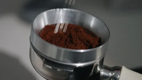 Manual coffee grounds distribution in espresso portafilter Stock Footage 340278322