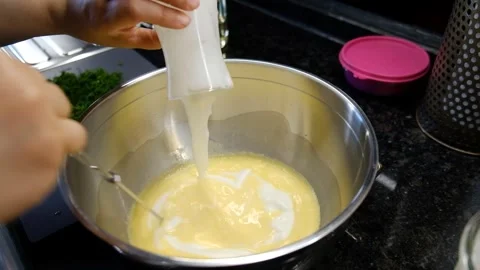 Manual Egg Beating in Deep Bowl with Cream Added While Mixing – Cooking Stock Footage 302687336
