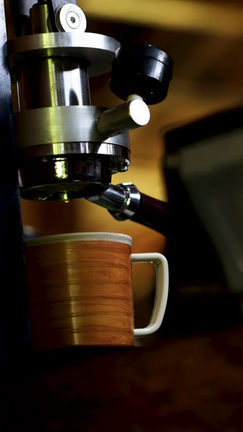 Manual espresso press machine extracting coffee drop into orange ceramic mu.. Stock Footage 344824162