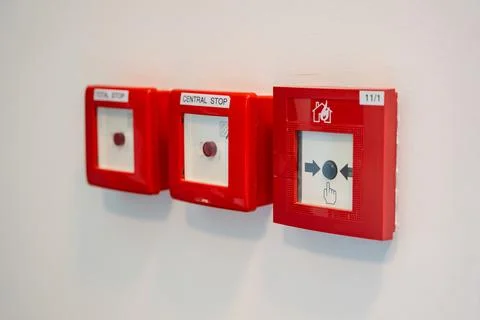 Manual fire alarm call points and emergency stop buttons installed on building Stock Photos