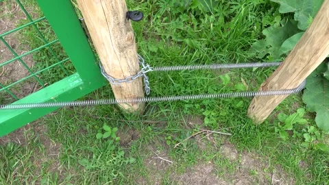 Manual gate with automatic self-closing by spring Stock Footage 311661376