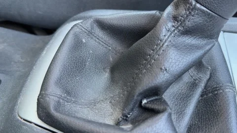 Manual gear stick is shifted inside a passenger car, close-up of textured black Stock Footage 337113122