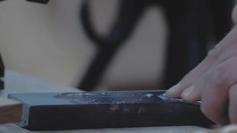 Manual grinding of a joiner's knife on a grindstone. 4k. 4k video. slow motion Stock Footage 116474928