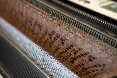 Manual knitting machine. A knitting machine is a device used to create knitte Stock Photos