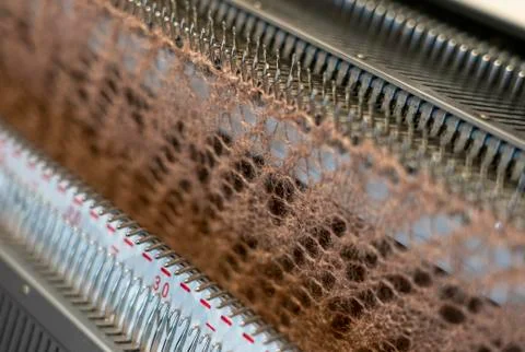 Manual knitting machine. A knitting machine is a device used to create knitte Stock Photos