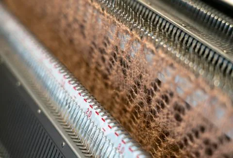 Manual knitting machine. A knitting machine is a device used to create knitte Stock Photos