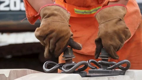 Manual Laborer Assembles Railroad Tracks in Buenos Aires, Focus on Hands Stockbeeldmateriaal 317675775