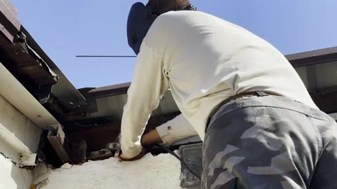 Manual laborer in protective mask welds iron detail at construction. Professiona Stock Footage 342438436