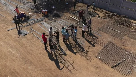 Manual Laborers Working with Concrete Mixer and Building Materials at Stock Footage 337790171