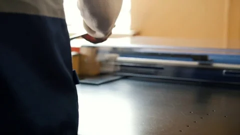 Manual labour - worker works at polygraph machine, printing industry Stock Footage 76932328
