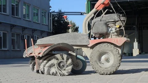 A manual machine for cleaning and sweeping streets is in the yard Stock Footage 116270207