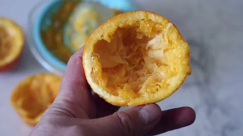 Manual orange juice squeezing, squeezed oranges, orange juice squeezing at .. 動画素材 235932242