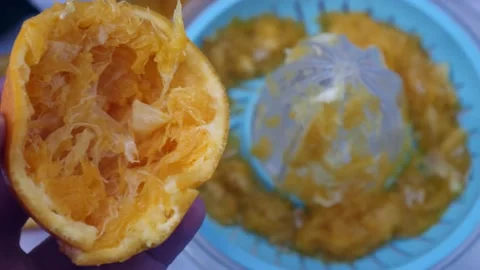 Manual orange juice squeezing, squeezed oranges, orange juice squeezing at .. Stock Footage 235932280