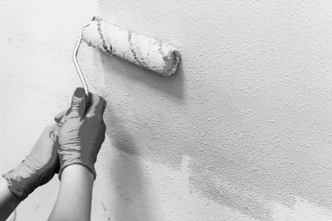 Manual painting of a wall using a roller roller, repair concept, Stock Photos
