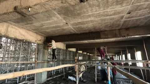 Manual Plastering Work on Building Ceiling by Laborers on Scaffolding at Stock Footage 340564286