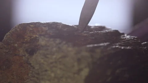 Manual processing of stone with strong back light in slow motion Stockbeeldmateriaal 146953429