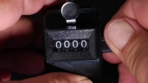 Manual reset of mechanical tally counter displaying Stock Footage 336965785