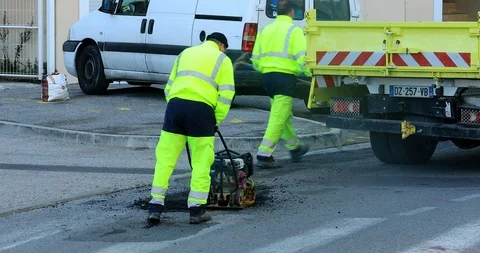Manual Road Repair Vibrating Machine Pushed By A Worker Stock Footage 99378548
