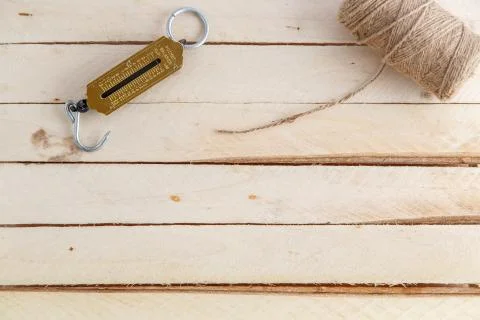 Manual scales and a thread for wrapping on wooden background Stock Photos