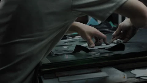 Manual Shoe Material Cutting and Assembly in Workshop Setting Stock Footage 341668183