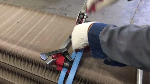 Manual strapping of packages for shipping Stock Footage 290885162