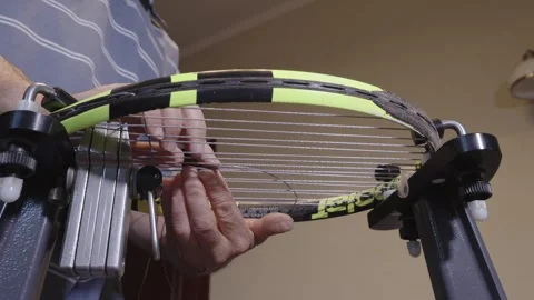 Manual stringing of a tennis racket on machine Stock Footage 317872342