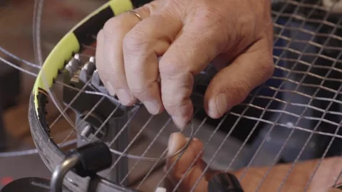 Manual stringing of a tennis racket on machine Stock Footage 317872353