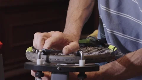 Manual stringing of a tennis racket on machine Stock Footage 317872354