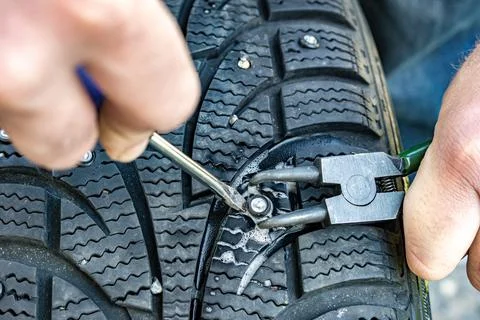 Manual stud installation using pliers and screwdriver Stock Photos