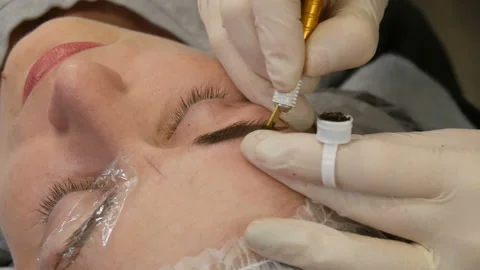 Manual technique of Microblading, master applies a special dark pigment with Stock Footage 162887080