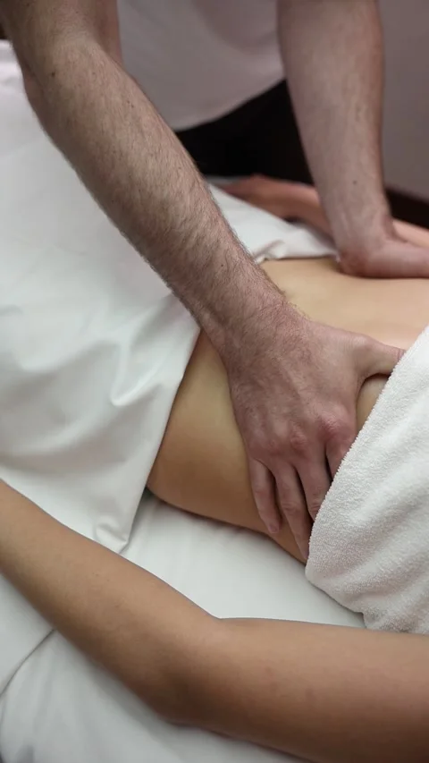 Manual Therapist Performing Lower Back Massage During Rehabilitation Stock Footage 340422967