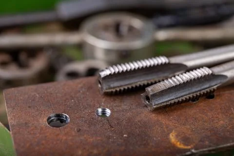 Manual thread cutting in metal. Locksmith accessories for small work in the h Stock Photos