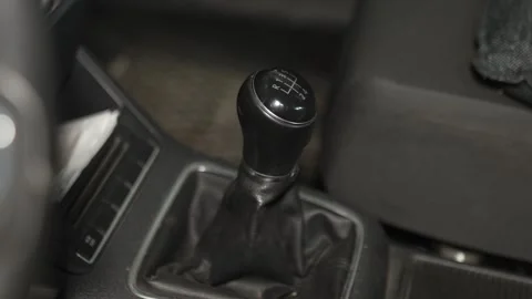 A manual transmission gear shift knob inside a car interior. Stock Footage 341334737