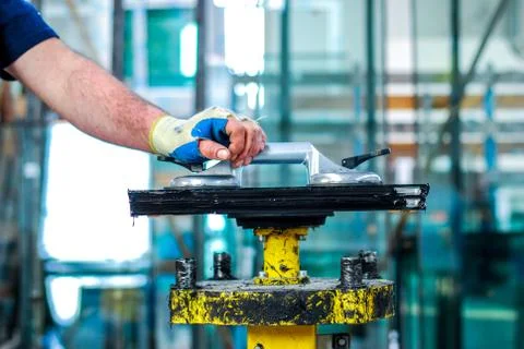 Manual worker assembling glass panels for PVC windows. Manufacturing jobs Stock Photos