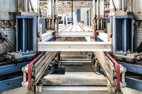 Manual worker assembling glass panels for PVC windows. Manufacturing jobs. Stock Photos