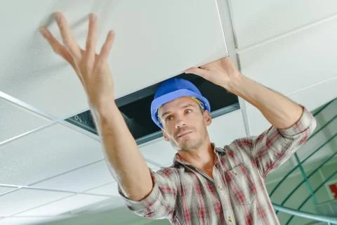 A manual worker inspecting ceiling Stock Photos