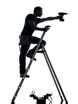 Manual worker man on stepladder drilling silhouette Stock Photos
