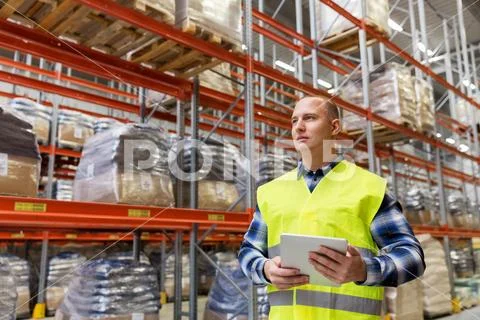 Manual worker with tablet pc at warehouse Stock Photos