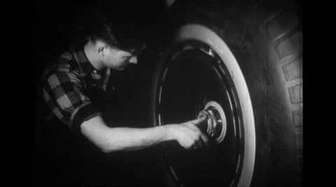 Manual worker testing a wheel of B-24 Liberator Stock Footage 39914107