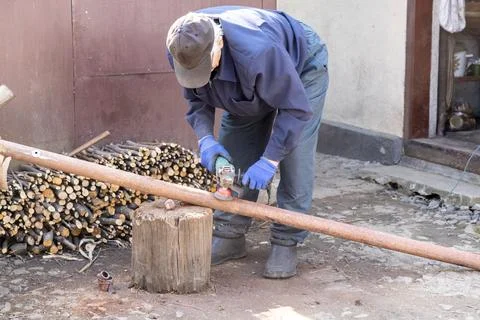 A manual worker uses a powerful angle grinder to clean a rusty metal pipe o.. Stock Photos