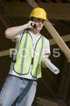 Manual Worker Using Cell Phone At Site Stock Photos