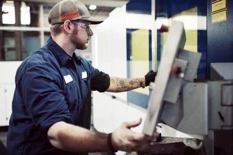 Manual worker using desktop computer in steel factory Stock Photos