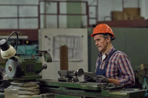 Manual worker using tablet pc in the plant Stock Photos