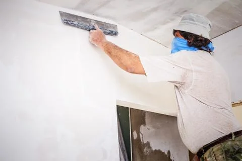 Manual worker with wall plastering tools Stock Photos