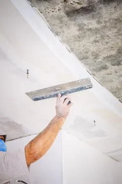 Manual worker with wall plastering tools Stock Photos