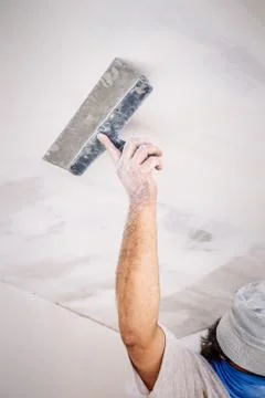 Manual worker with wall plastering tools Stock Photos
